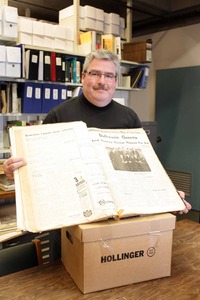 University Archivist Michael Moosberger displaying an issue of the Dalhousie Gazette
