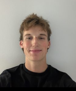 AJ Irving smiling in a professional headshot.